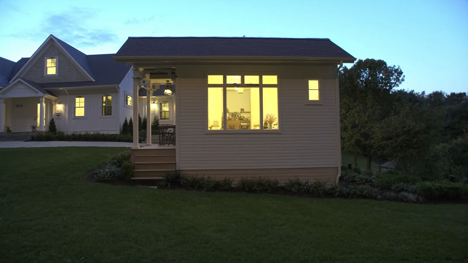 The same backyard after ADU construction — detached one-bedroom ADU with private entrance and covered porch