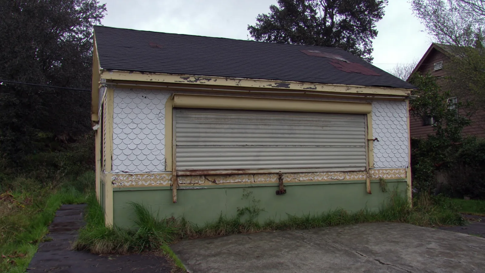 San Diego garage before conversion — unfinished concrete block structure used for storage